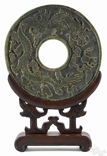 Large Chinese spinach jade disc with relief dragon decoration, the reverse with an incised phoenix