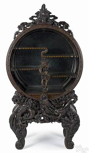 Chinese carved display cabinet, early 20th c., with a rotating tambour action opening, 72'' h.