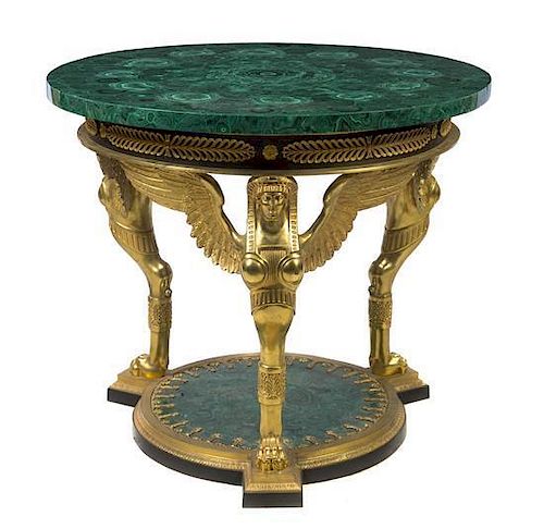 A French Empire Style Gilt Bronze Mounted and Malachite Veneered Gueridon, Height 35 3/4 x diameter 41 1/4 inches.