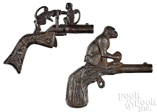 Two cast iron animated monkey cap guns