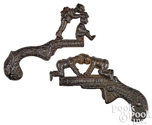 Two cast iron animated cap guns