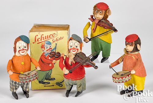 Four Schuco wind-up toys