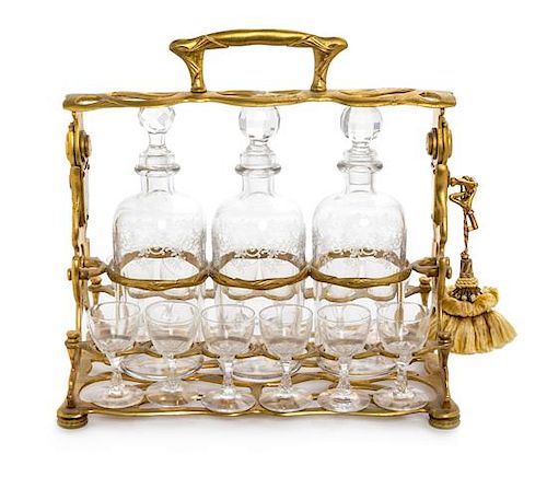 A French Gilt Metal and Glass Tantalus Width 11 1/2 inches.