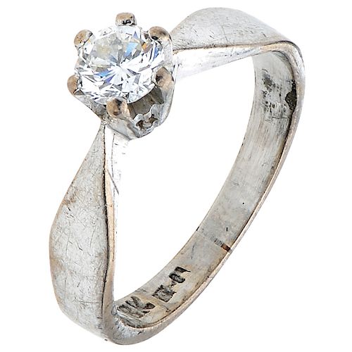A 10K white gold solitaire ring.