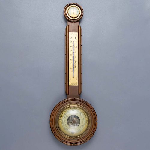 Barómetro. Alemania. SXX. Marca HUGER. Aneroide. Cuenta con termómetro e higrómetro. Elaborado en madera, cristal y metal dorado.