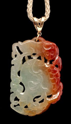 A CARVED RUSSET JADE PENDANT WITH 14K GOLD MOUNT