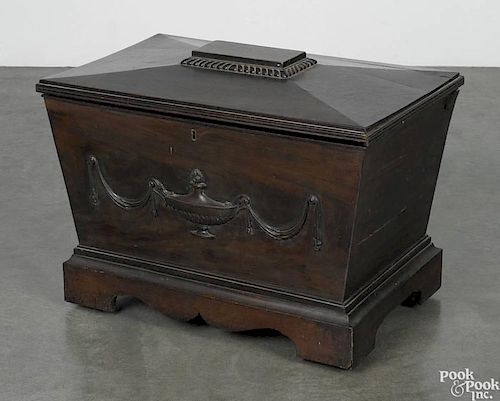 Regency mahogany cellarette, early 19th c., of sarcophagus-form with an applied urn and swag front
