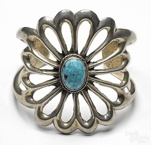 Silver Southwestern style cuff bracelet with open floral design and an oval turquoise cabochon