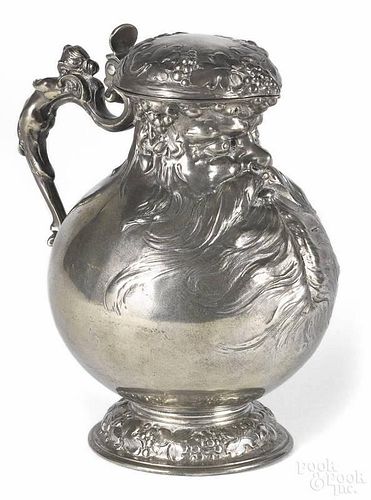 German pewter wine pitcher, late 19th c., adorned with a bearded gentleman, grapevines, and a cherub