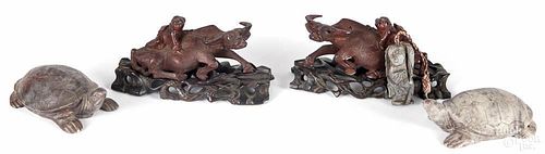 Chinese carved figural groups, to include a pair of reclining wooden oxen being ridden by children,