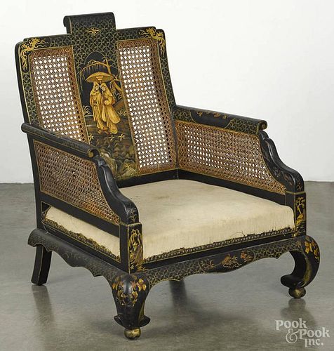 Chinese black lacquer armchair with a caned back.