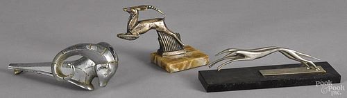 Three vintage hood ornaments, to include a ram, an impala, and a pair of greyhounds.