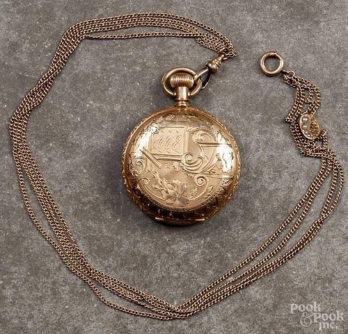 Lady's Elgin pocket watch with a 14K yellow gold hunting case supported by a gold-filled chain