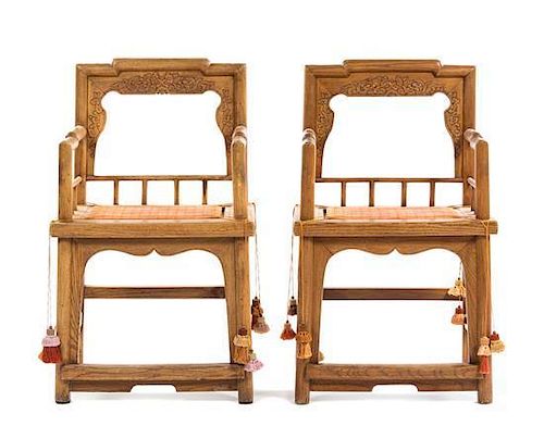 A Pair of Carved Wood Armchairs Height 37 inches.