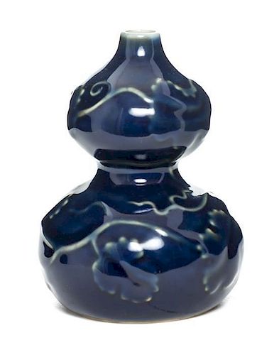 A Cobalt Molded Porcelain Gourd-Form Vase Height 4 5/8 inches.