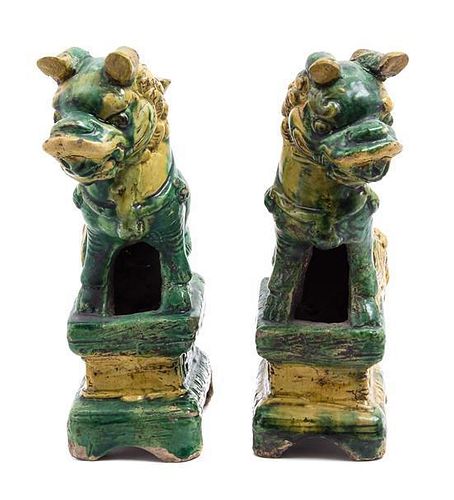 A Pair of Pottery Figures of Temple Lions Height 8 1/2 inches.