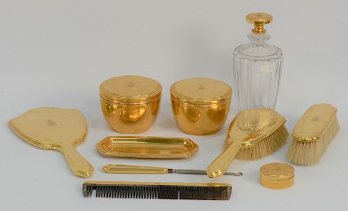 Tiffany & Co. 18 karat gold ten piece dresser set, 
two covered gold jars, a pin tray, a small gold round box, hand mirror, two brus...
