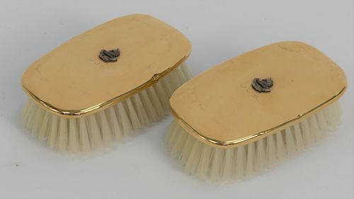 Three piece 14 karat gold lot to include a pair of 14 karat gold brushes, 
mounted with silver family crest, initialed J.J.S., and a...