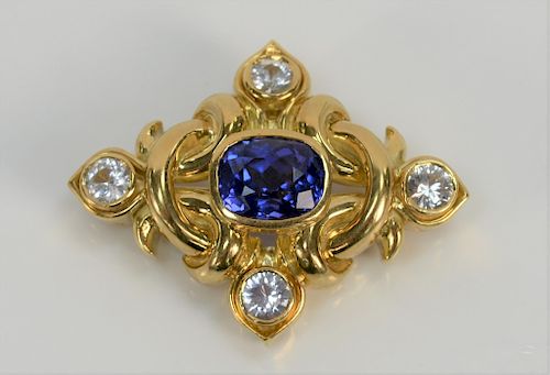 18 karat gold brooch/pendant, set with center tanzanite and with four white topaz. height 1 1/4 inch, width 1 5/8 inch, 23.3 grams tota...
