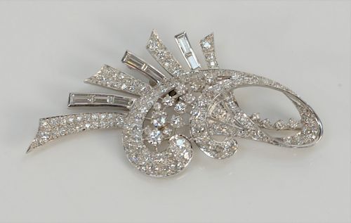 Platinum and diamond free form brooch set with round diamonds and baguettes. 
height 2 1/4 inches