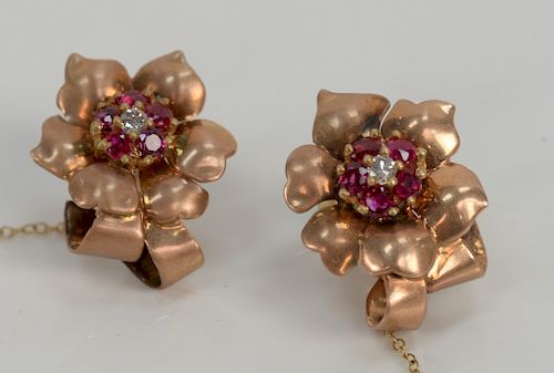 14 karat pink gold earrings, set with five rubies and one diamond each. 
10 grams total weight