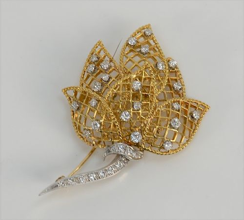 18 karat yellow gold floral pin with white gold stem, set with thirty-six diamonds.
height 2 1/8 inches, 13 grams
