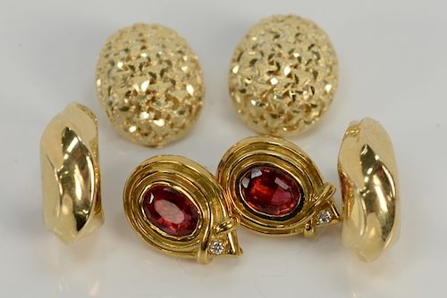 Three pairs of 18 karat gold earrings to include two pierced and one ear clip, one pair set with red stones, and one with small diam...