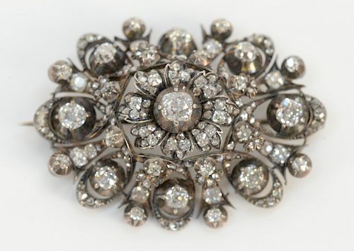 Georgian diamond brooch, silver top with 10 karat gold back, set with old mine and rose cut diamonds, 
center diamond of approximate...