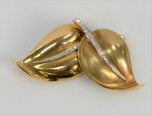 18 karat double leaf brooch set with twenty-nine diamonds with 14 karat pin. 
24.7 grams