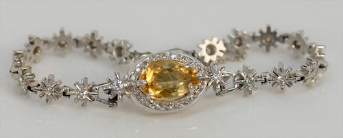 14 karat white gold bracelet set with marquise cut dark yellow stone with diamond surround, bracelet made of sixteen stars, each mou...