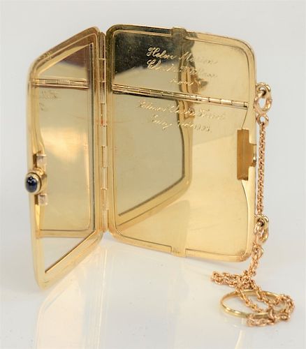 14 karat gold compact with chain and sapphire, monogrammed, circa 1908. 
2 1/8" x 3", 98 grams (without mirror)