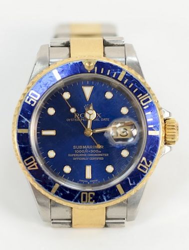 Rolex Submariner mens wristwatch, 
having blue dial and bezel gold and stainless band, being sold with original box and papers.