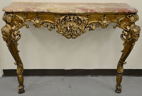 Pair of French Regence console tables with marble tops, 
on carved bases, set on hoof feet, probably 19th century. 
height 34 inches...
