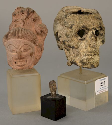 Three early sculptures of busts, iron skulls, stone Chinese bust, and a miniature stone head