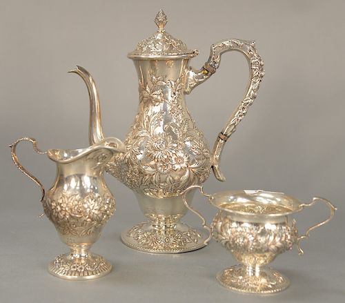 S. Kirk & Sons three piece tea set, 
with all over repousse teapot, sugar, and creamer. 
pot: height 9 1/2 inches 
28 total troy ounces