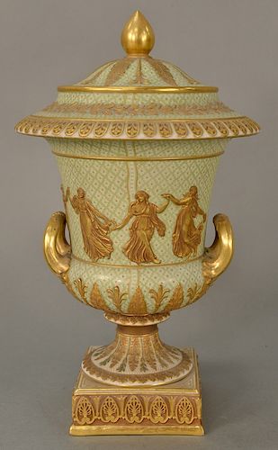 Wedgwood gilt decorated Victoria ware covered urn, 
pale green with gold jeweled ground, gilt relief figures and foliate banded bord...