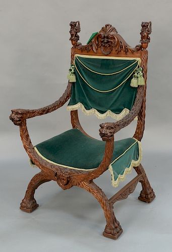 Carved mahogany armchair with winged griffin finials and lion carved hand rests, 
fur style carved arms and legs ending in paw feet ...
