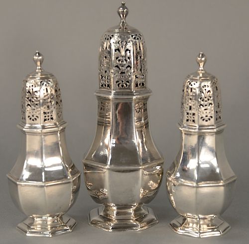 Charles Adams three sugar casters,  one large and a pair, all eight sided, circa 1719.  largest: ht. 7 1/2 inches (19.1 cm)  p...