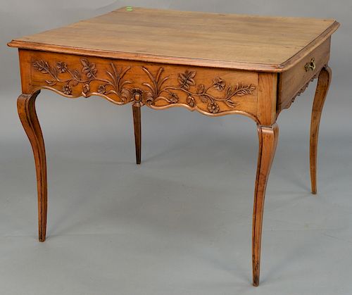 Louis XV fruitwood center table with drawer on either end with floral carved sides, set on delicate cabriole legs, 18th century. 
he...