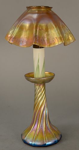 Tiffany art glass lamp, 
scallop edge shade, iridescent gold with pink highlights, candle style base with twisted bulbous base and i...