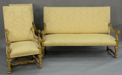 Louis XIV style eight piece salon suite to include sofa, loveseat, and six armchairs,  all with carved gilt decorated arms, legs, an...