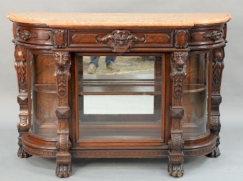 Victorian walnut curio cabinet having salmon color marble top,  over center drawer, flanked by pull-out side drawers over center gla...