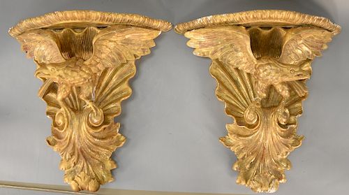 Pair of carved giltwood and gesso eagle bracket shelves, 
each with spreading eagle rocaille and acanthus carving, 19th century (rep...