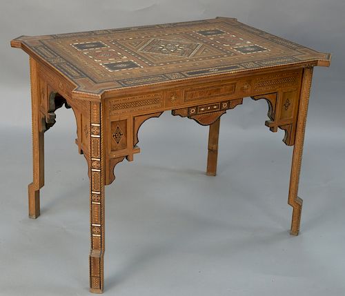 Mid-Eastern table of various woods and mother of pearl inlays in stars and geometric forms, set on square inlaid legs.  height 28...