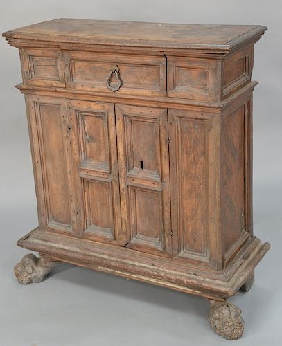 Continental carved walnut commode, 
possibly late 17th century, with later elements, short drawer over paneled cupboard doors, on pa...