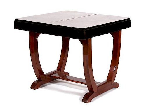 An Art Deco Mahogany and Black Lacquer Dining Table Height 31 x width 35 1/2 x depth 37 3/4 inches.