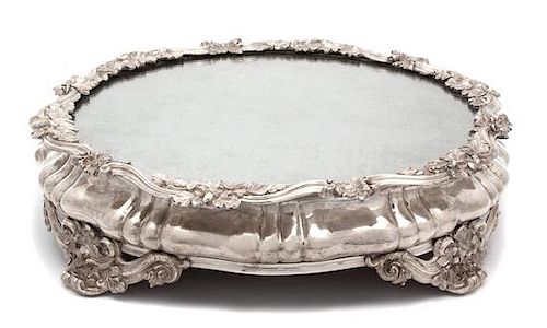 A Continental Silver Plate Mirror Top Plateau, 19TH CENTURY, having scrolll and oak leaf border and feet.