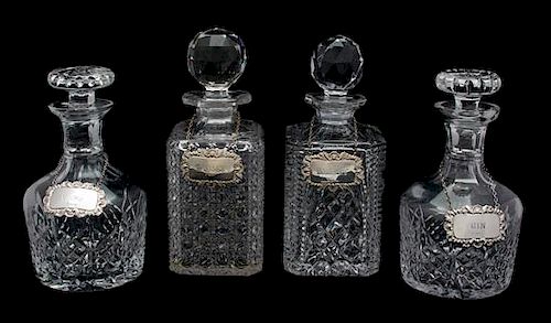 Four Cut Glass Decanters with English Silver Labels Height of tallest 10 inches.