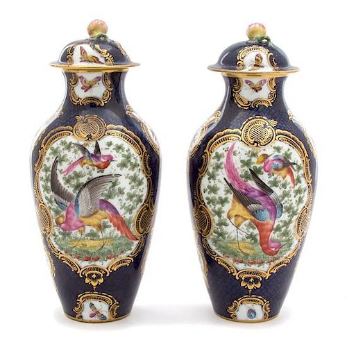 A Pair of English Chelsea Polychomed Porcelain Lidded Urns Height 10 1/2 x diameter 4 1/2 inches.