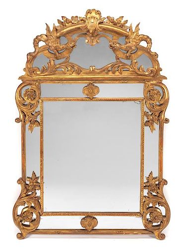 A Regence Style Giltwood Mirror Height 67 1/2 x width 47 inches.